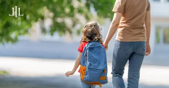 child and parent going to school